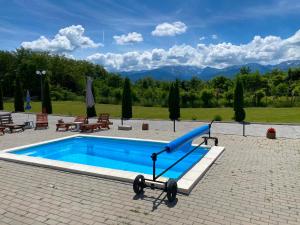 a swimming pool with a blue slide in a park at Best Vila Valea Avrigului in Avrig