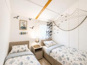 a bedroom with two beds and a window at Domki Promyk in Mrzeżyno +75 photos