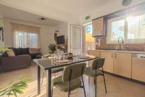 a kitchen and living room with a table and chairs at San House 1 in Archangelos +8 photos