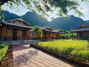 a row of houses with mountains in the background at Duong Cong Chich Homestay in Lạng Sơn