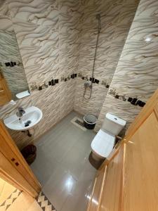 a bathroom with a toilet and a sink at Catrass Oualidia Apartments in Oualidia