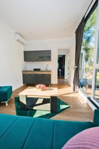 a living room with a blue couch and a table at EloA Glamping in Petrovac na Moru