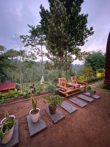 a garden with a bench and potted plants at Bunga Lodge Tetebatu in Tetebatu
