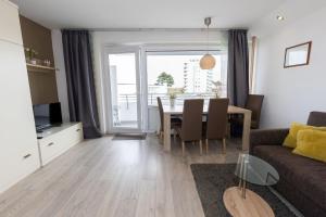 a living room with a table and a dining room at Hanseatic 208 in Duhnen