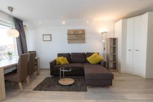 a living room with a couch and a table at Hanseatic 208 in Duhnen