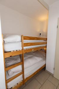 a group of bunk beds in a room at Hanseatic 208 in Duhnen +15 photos