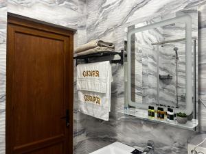 a bathroom with a sink and a mirror and towels at Готель Сузірʼя in Kolomiya +32 photos