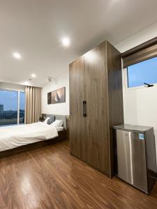 a bedroom with two beds and a large window at Sky villas with large balcony in Hanoi
