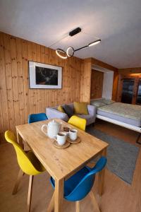 a living room with a wooden table and chairs at Vue Alpes imprenable - Centre - 4 Vallées in Nendaz
