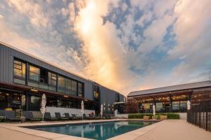 a building with a swimming pool in front of a building at Luxury Apartment - Breathtaking River Views in Kyalami