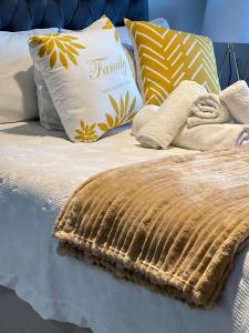 a bed with a blanket and pillows on it at Luxury Apartment - Breathtaking River Views in Kyalami +88 photos