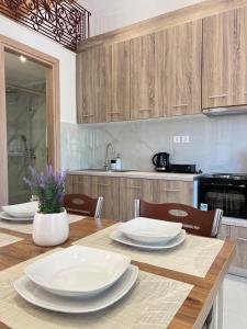 a kitchen with a wooden table with white plates on it at evelinas view 3 in Mytilene