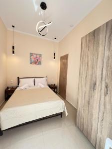 a bedroom with a bed and a large wooden cabinet at evelinas view 3 in Mytilene
