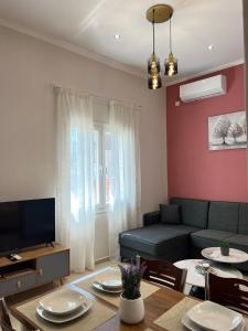 a living room with a couch and a table at evelinas view 3 in Mytilene