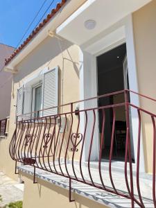a balcony of a house with a red railing at evelinas view 3 in Mytilene