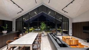 a large dining room with a long table and chairs at Chalet Rila in Govedartsi