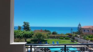 a view of the ocean from a balcony at Skidi Beach house in Ágios Matthaíos