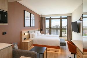 a hotel room with a bed and a large window at Residence Inn Lisbon by Marriott Hotel in Lisbon