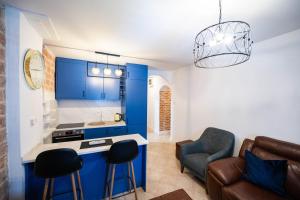 a kitchen and living room with blue cabinets at Serenity Sea in Perast