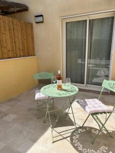 a patio with a table and chairs and a window at Chambre Villa piscine in Saint-Tropez