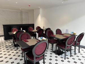 a row of tables and chairs in a restaurant at Classy Central Hotel in Hanoi