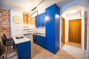 a blue kitchen with a counter and a table at Serenity Sea in Perast +23 photos