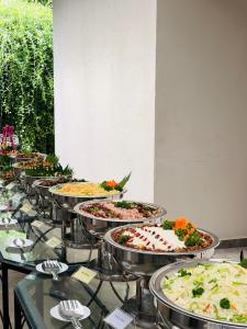 a bunch of pizzas on display on a table at Hotel Water Nest in Etagama