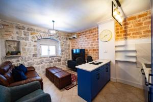 a living room with a brick wall at Serenity Sea in Perast