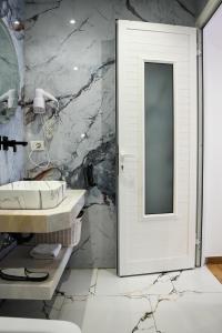 a bathroom with a sink and a mirror at Blue Heaven Seaside in Borsh +160 photos
