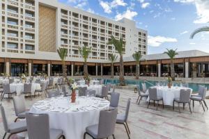 a group of tables and chairs in front of a building at The Landmark Nicosia, Autograph Collection in Nicosia
