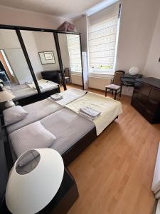 a bedroom with a large bed and a desk at Apartment BOZ Solingen 100m2 in Solingen