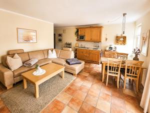 a living room with a couch and a table at Apartmenthaus Ostseewelle Ferienwohnung 13 in Kühlungsborn