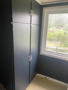 a gray cabinet in a room with a window at Tiritoppen Cabin in Loen +10 photos