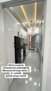 a small kitchen with a stove and a refrigerator at Terras Astara in Astara