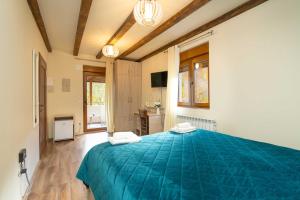 a bedroom with a large blue bed in a room at Zvjezdana dolina Garni hotel in Andrijevica