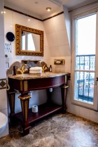 a bathroom with a large sink and a mirror at La Villa Royale in Paris +73 photos