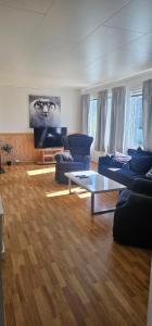 a living room with blue couches and a table at Nord Hus 3 in Loppa