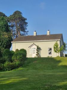 a house on a hill with a green yard at Drumee Lodge boutique B and B, Newcastle, County Down in Newcastle