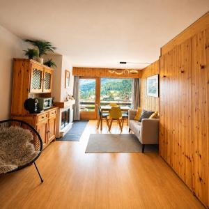 a living room with a couch and a table at Vue Alpes imprenable - Centre - 4 Vallées in Nendaz +10 photos