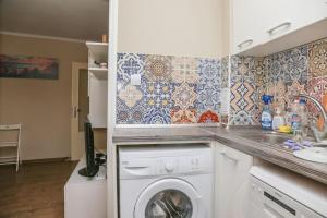 a kitchen with a washing machine and a sink at Top Centre, Quiet, Independant in Burgas +2 photos