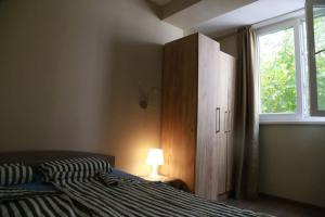 a bedroom with a bed and a dresser and a window at Top Centre, Quiet, Independant in Burgas