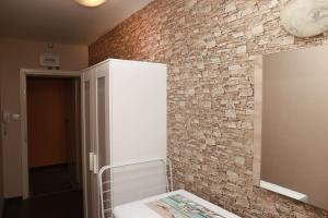 a bathroom with a brick wall and a mirror at Top Centre, Quiet, Independant in Burgas