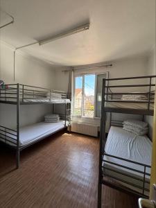 a room with two bunk beds and a window at Soleil in Villejuif