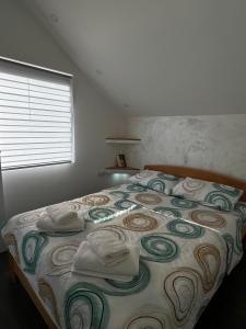 a bedroom with a bed with towels on it at Apartman Nastić in Lazarevac