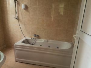 a bath tub in a bathroom with a shower at STOP otel in Sheki +36 photos