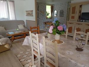 a living room with a table with a vase of flowers at La Planoise in Autun