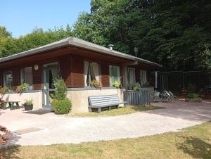 a house with a bench in front of it at La Planoise in Autun