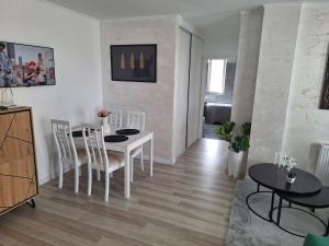 a living room with a white table and chairs at Cozy apartment! in Floreşti +2 photos