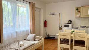 a small room with a bed and a window at HollidayVillage 5B in Matka Božia