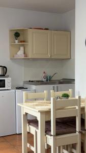 a kitchen with a table and chairs in a kitchen at HollidayVillage 5B in Matka Božia +8 photos